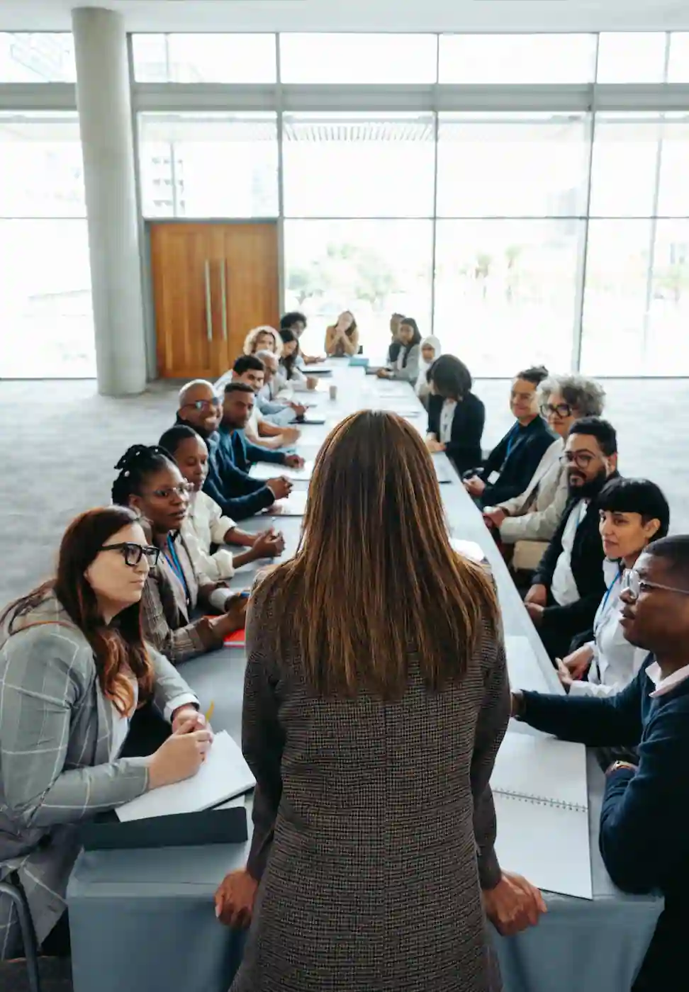 Empowered woman leading a diverse group meeting in a modern office setting