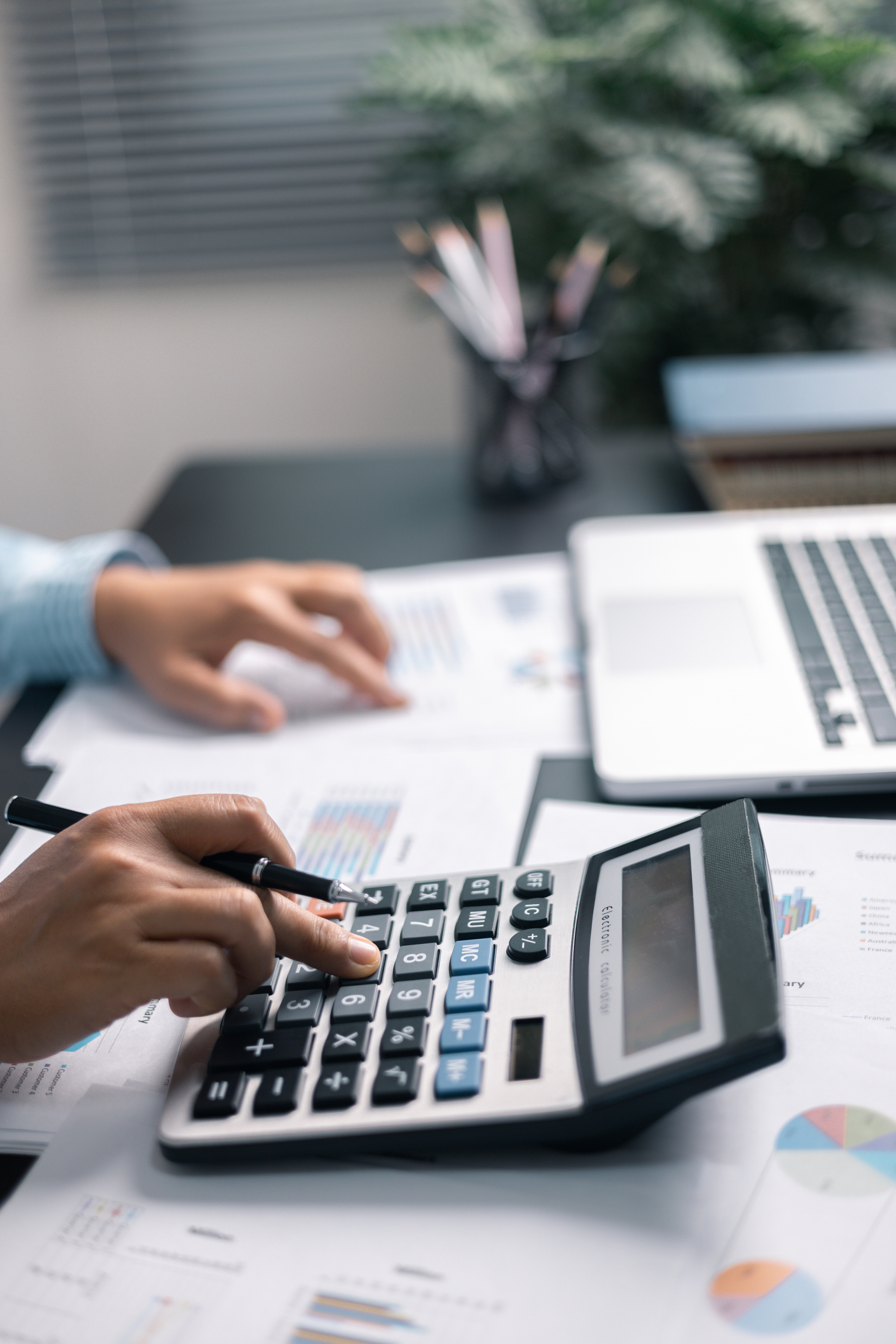 Finance bank tax expense accounting budget money businessman hand use Financial calculate accountant close up calculator with graph chart write office desk Business expense analysis saving home car